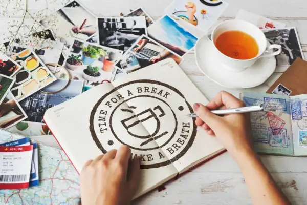A designer hand-sketching a circular branding emblem, part of professional services offered by graphic designers.